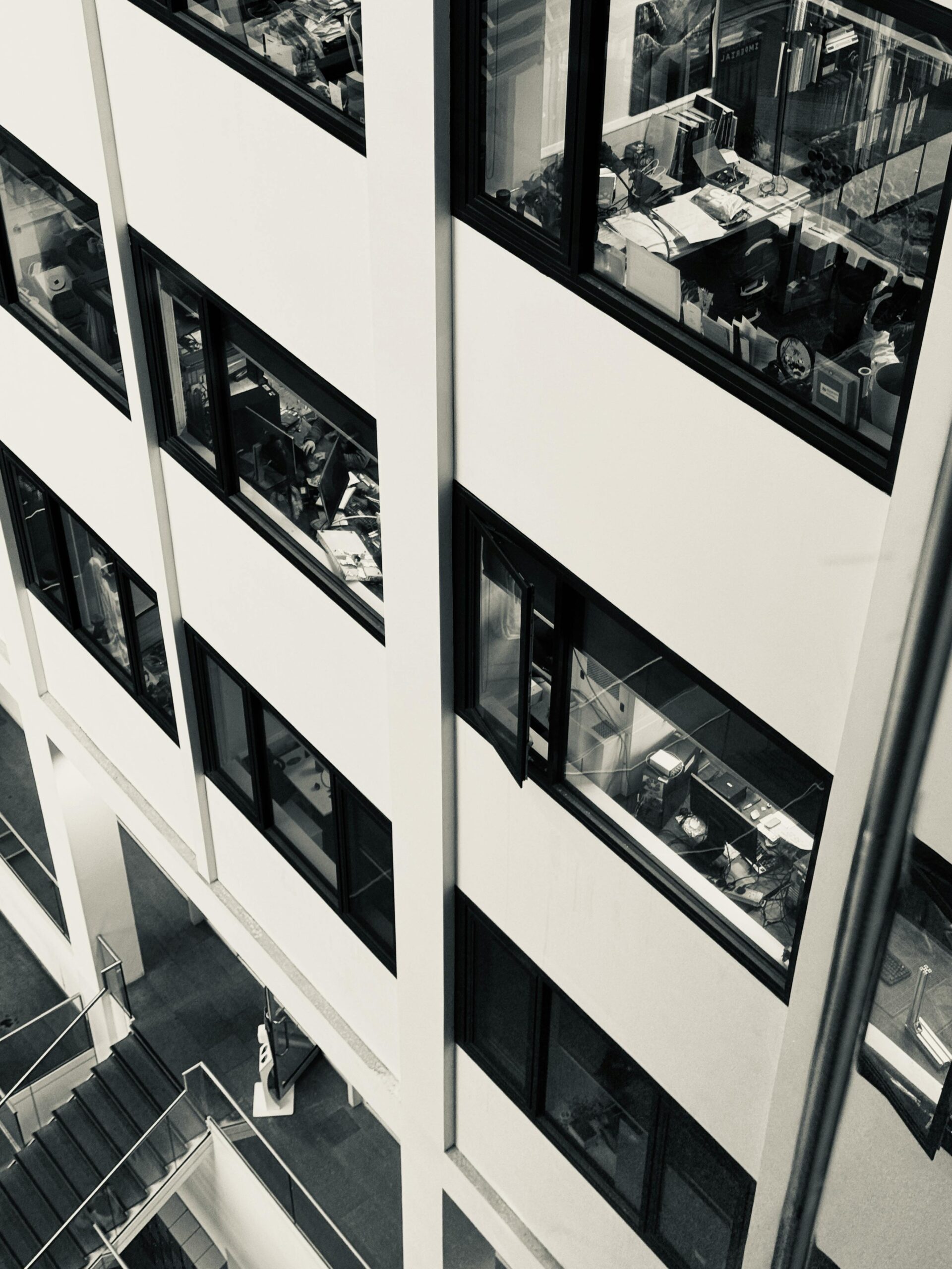 High-angle view of a bustling office with visible desks and employees.